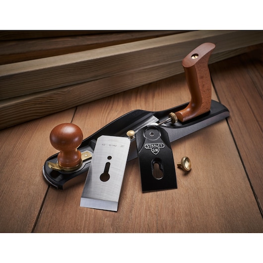 STANLEY 1-12-137 hand plane with wooden handles and metal parts, shown disassembled on wood surface.