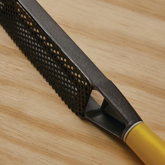 STANLEY 21-295 hand rasp, close-up of black metal blade and yellow handle on wood surface.
