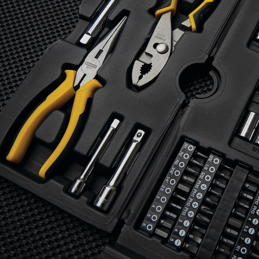 Stanley SKU 97-543 tool set photography, showing pliers, bits, and sockets in black molded case, angled view.