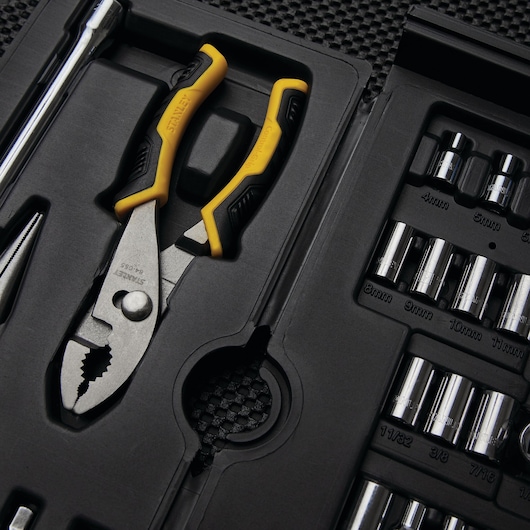 STANLEY 97-543 tool set with yellow and black pliers, assorted sockets, and a case insert, angled view.