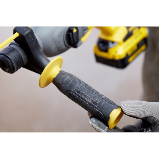 Stanley SBH900M2K-B3 drill handle close-up in black and yellow with textured grip and gloved hand.