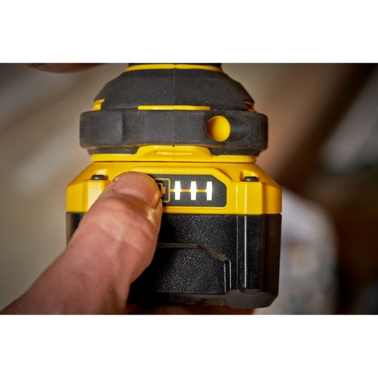 STANLEY SBW920M2K battery indicator close-up, yellow and black, with finger pressing power button.