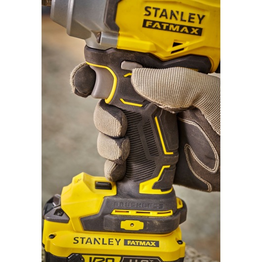 Photo of STANLEY SBW920M2K Fatmax cordless brushless drill held by gloved hand, close-up side view.