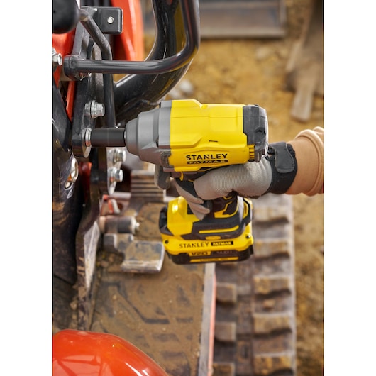 STANLEY SBW920 impact wrench in use on machinery, close-up angle, yellow and black design.
