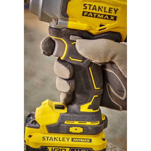 Stanley SBW920 FATMAX brushless power tool handle held by gloved hand, close-up photo