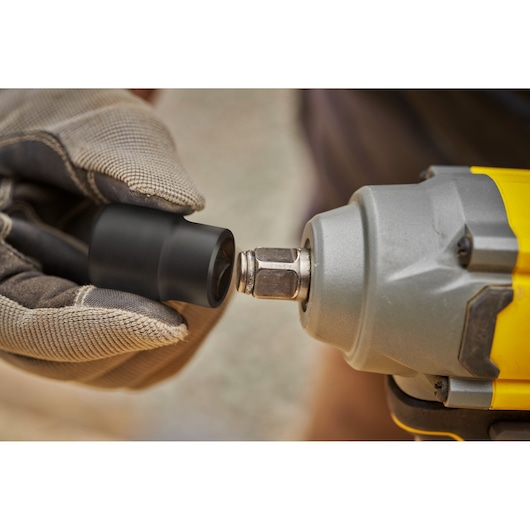 STANLEY SBW920 impact wrench close-up, gloved hand attaching black socket, tool photography.