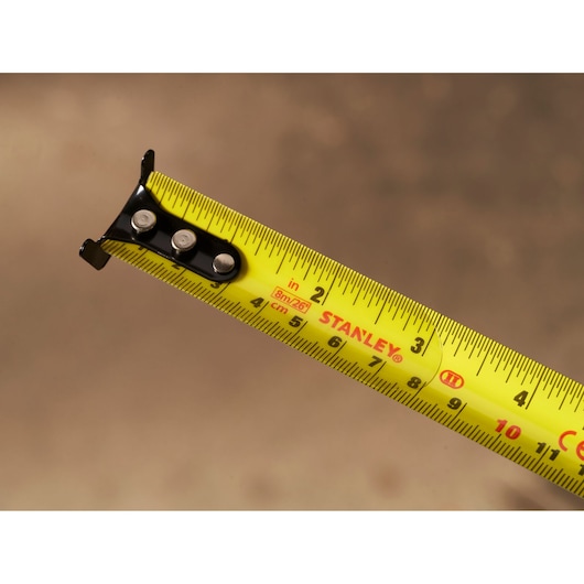 STANLEY STHT37247-0 yellow tape measure close-up showing inch and centimeter markings.