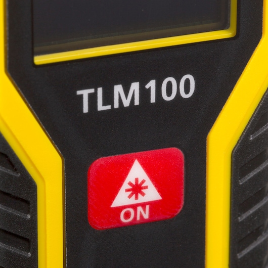 STANLEY STHT77410 photography, close-up of TLM100 laser measurement tool with yellow and black accents and ON button.