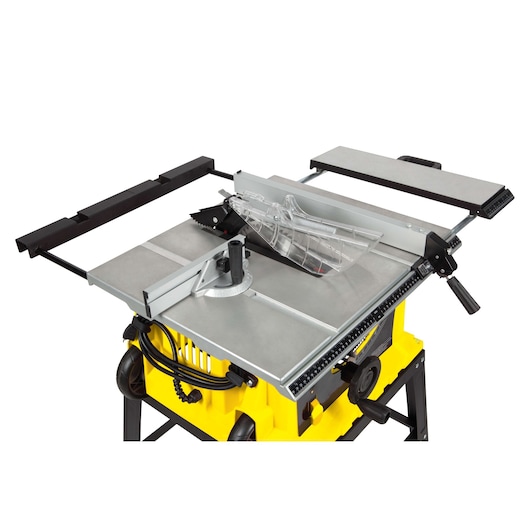STANLEY STST1825 table saw with yellow base, metal work surface, clear blade guard, and side extension, studio angle.