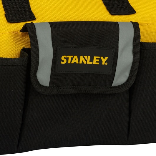 Photo of STANLEY STST512114 tool bag, black with yellow accents, front pocket and reflective gray trim, front angle.