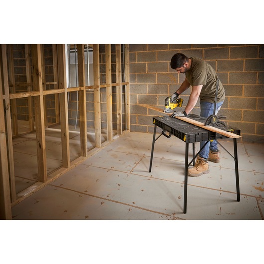 STANLEY STST83492-1 work table used for sawing wood in a construction photography scene.